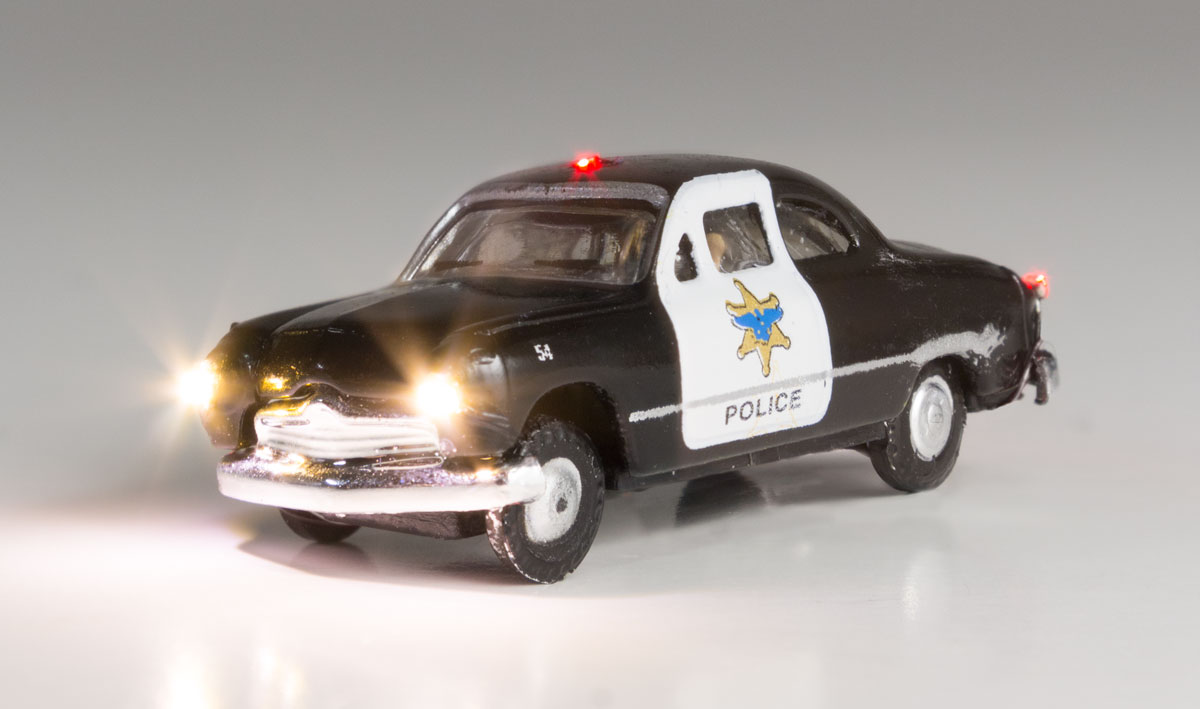 Police Car - N Scale - Protecting the town and looking for hooligans, this Police Car isn't afraid to flag down those rambunctious law breakers